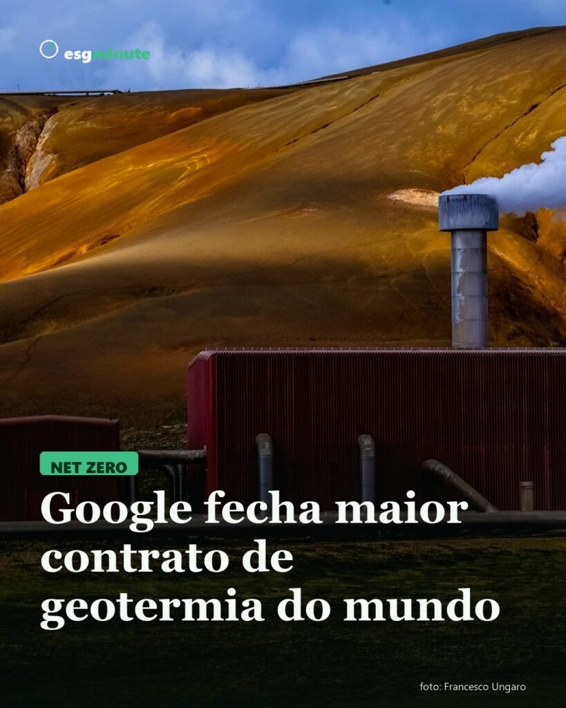 Usina geotérmica com chaminé soltando vapor entre colinas